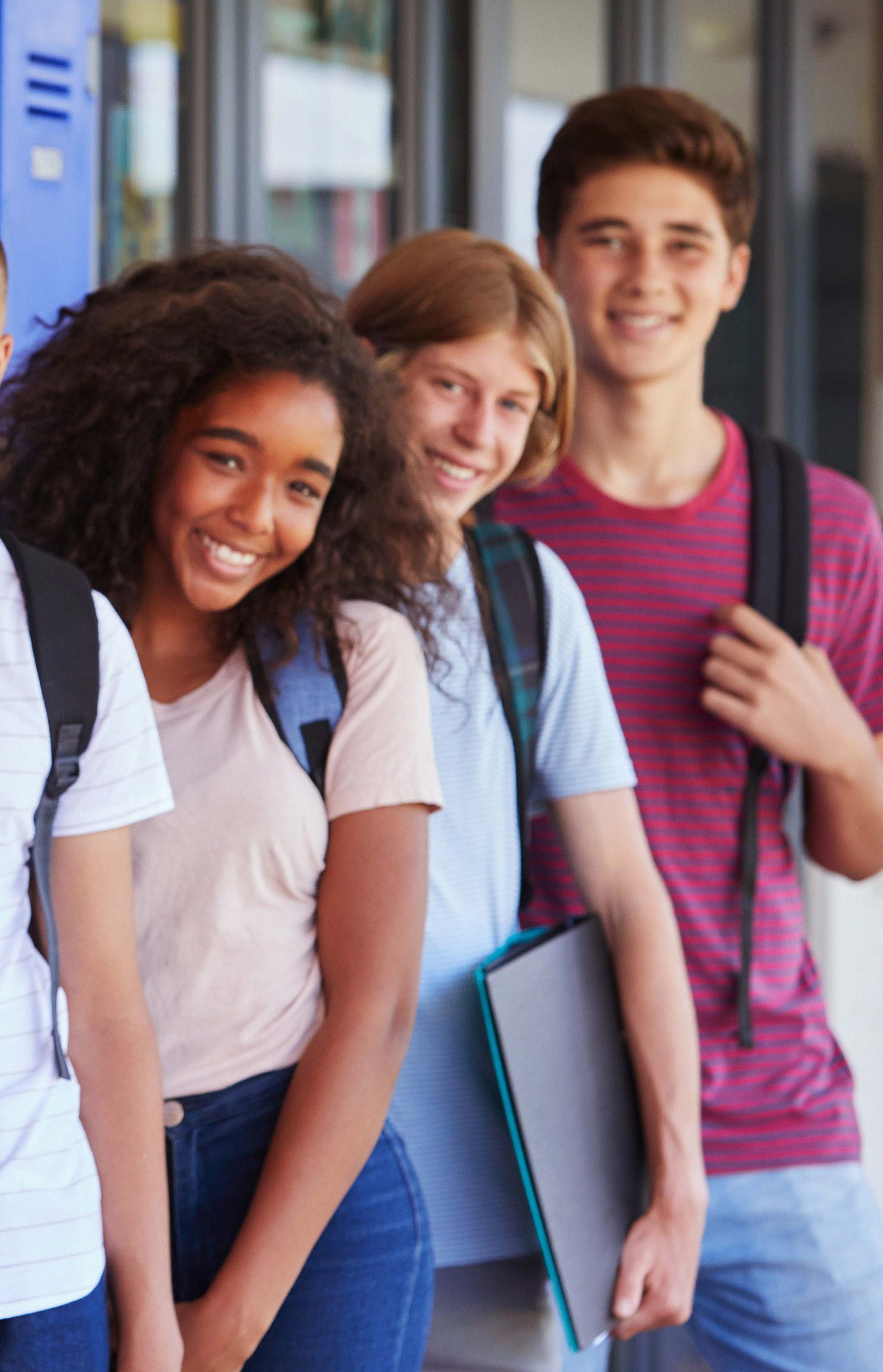 teenage,school,kids,smiling,to,camera,in,school,corridor